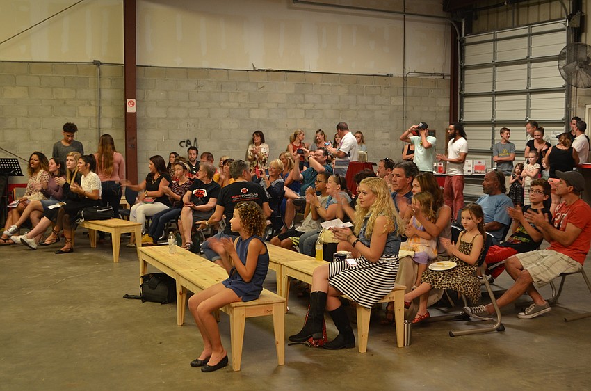 Attendees clap for the student performers.