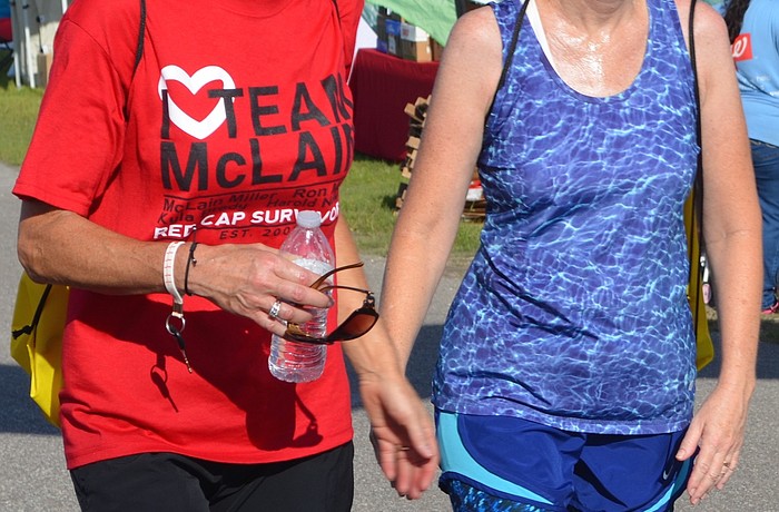 Cheryl Track, 49, with her friend Anne Swartz, 51, smile as they take their last steps before finishing the Heart Walk.