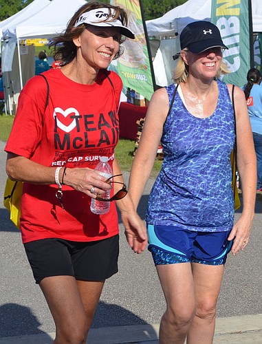 Cheryl Track, 49, with her friend Anne Swartz, 51, smile as they take their last steps before finishing the Heart Walk.