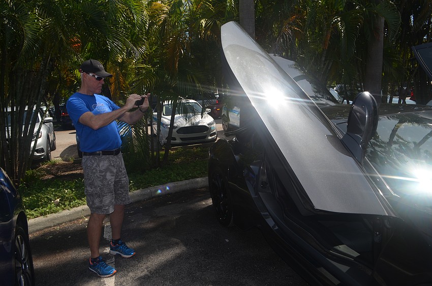 Randy Richards takes a photo of a BMW i8.