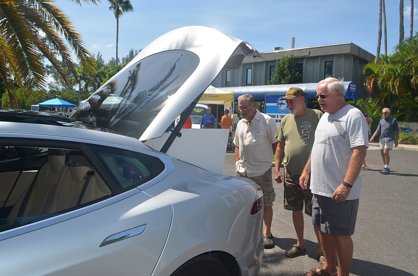 Dave Fach, Wayne Freeman and Gordon Bremer check out a 2014 Tesla Model S.