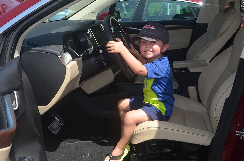 Parker Royalty, 3, takes a turn in the driver’s seat of a 2016 Tesla Model X.