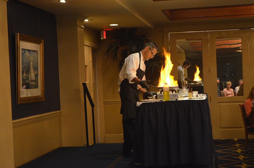 Chef Brent Williams begins cooking the steak diane dish.