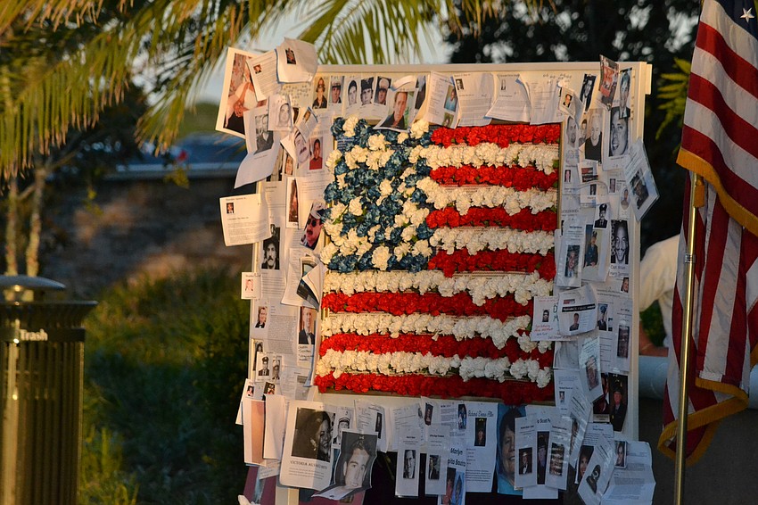 Guests added flowers and photos to represent their adopted fallen in the ceremony.