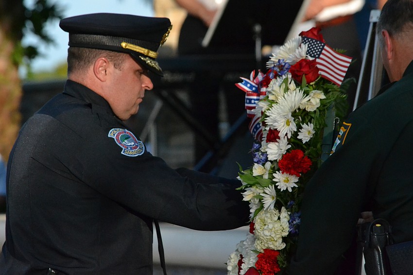 Sarasota Police Department Deputy Chief Patrick Robinson presents a wreath with Sheriff Tom Knight for the families of 9/11 victims.