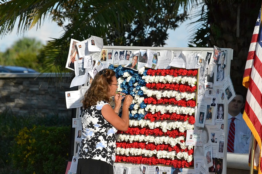 Kim Corbett sticks a final flower into the arrangement.