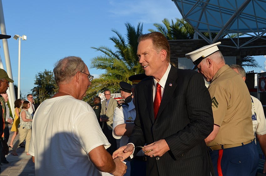 Rep. Vern Buchanan hands out commemorative coins to veterans and first responders.