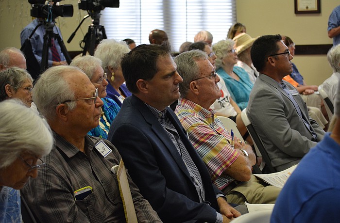 East County resident Jack Williams, center in sport coat, remains unconvinced that Manatee County should have a new half-cent sales tax.