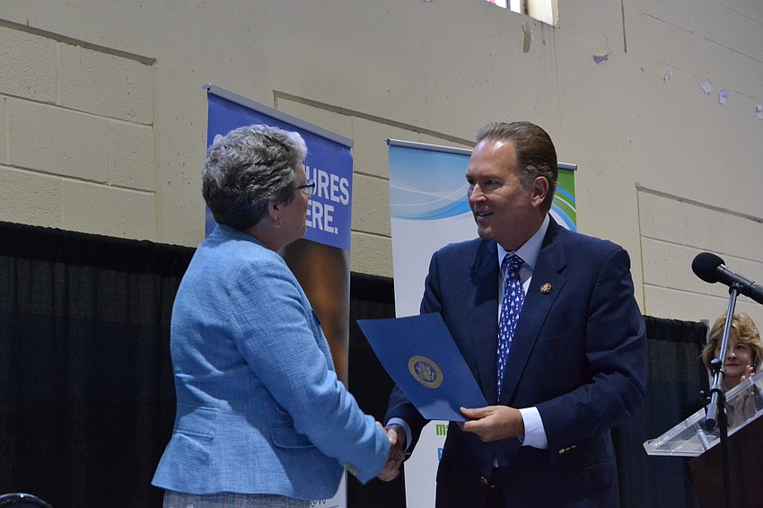 Former CYD Executive Director Karen Bogues is recognized by Rep. Vern Buchanan during the presentation.