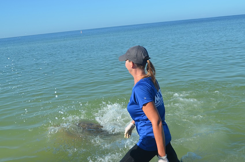 Jenna Rouse watches as Tucker B. heads out into deeper water.