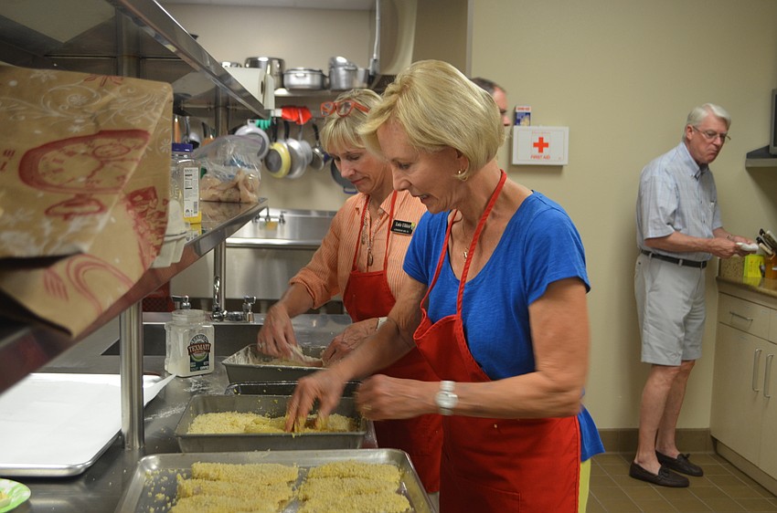 Lutie Uihlein and Sally Rauch batter the fish for Christ Church’s annual fish fry.