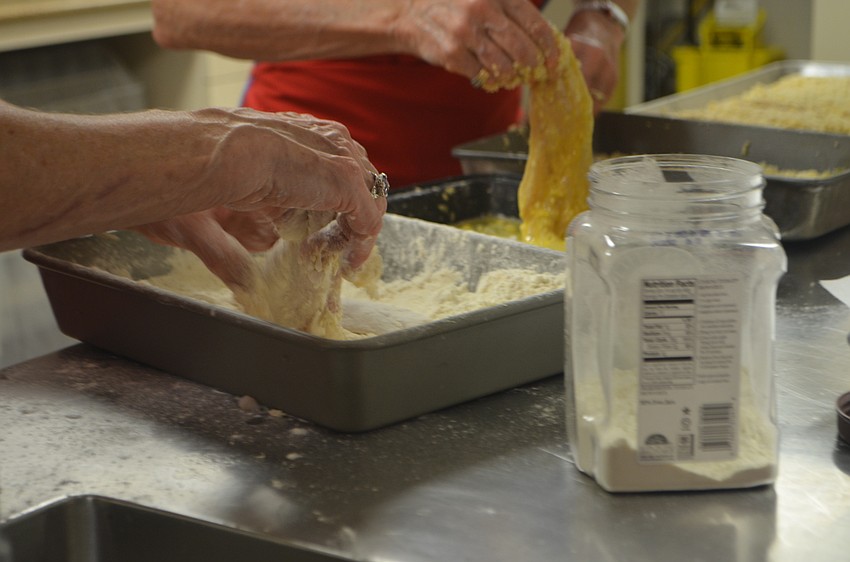 Lutie Uihlein helps prepare the fish for Christ Church’s fish fry on Sept. 16.