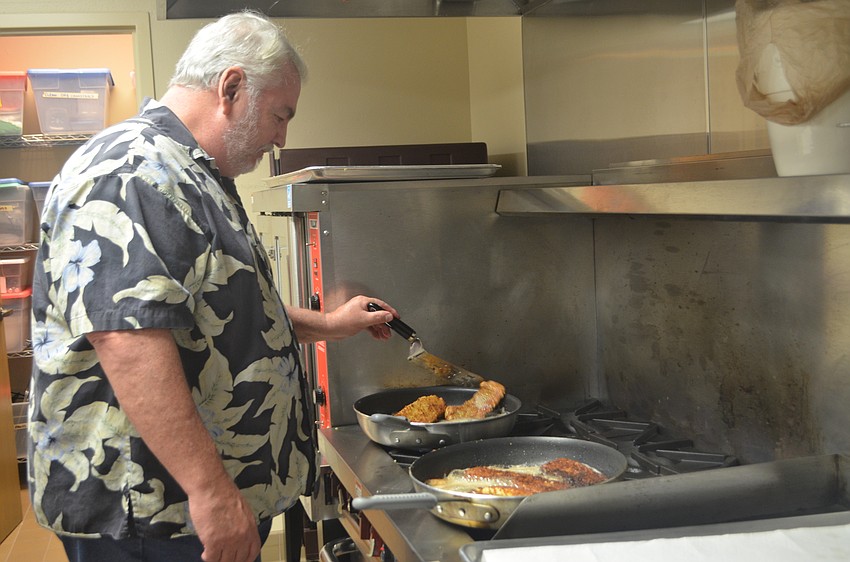 Mark Huber cooks the fish he caught with Mark Huber. The two spend about three months catching enough fish for the event.