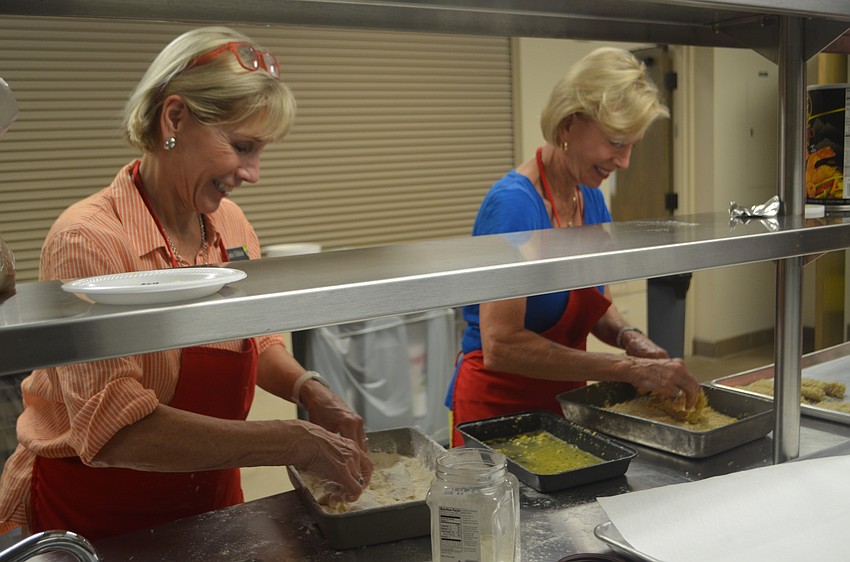Lutie Uihlein and Sally Rauch help batter the fish during Christ Church’s fish fry on Sept. 16.