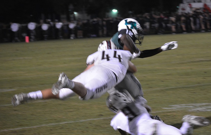 The Pirates played some high-flying defense as shown here by linebacker Matthew Haftke and defensive back Tommie Battie as they hit Lakewood Ranch wide receiver Stephon Turner.
