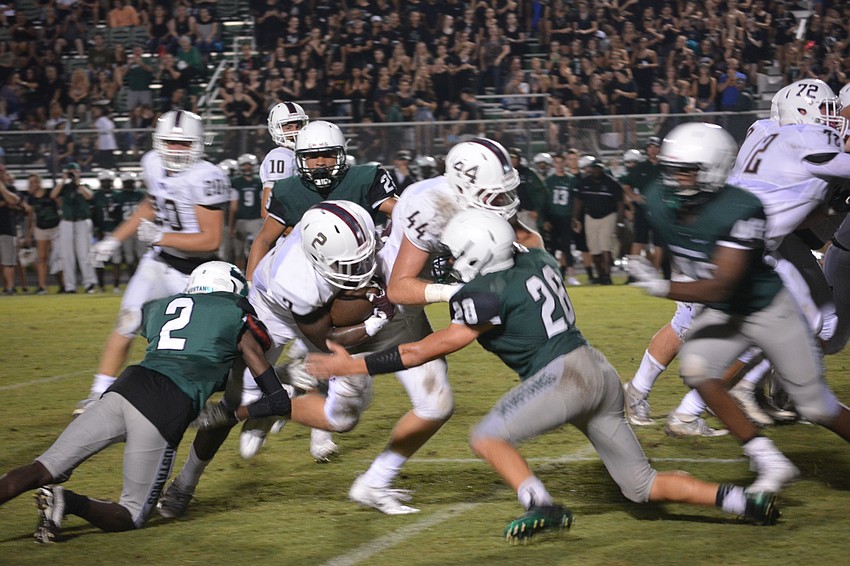 Lakewood Ranch's defense had a huge first half, such as this play when Mark Davis (2) and Noah Ben-guzzi meet Braden River running back Deshaun Fenwick in the hole.