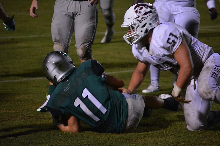 Lakewood Ranch's Mason Fischer gets crunched by Braden River's Noah Arce.