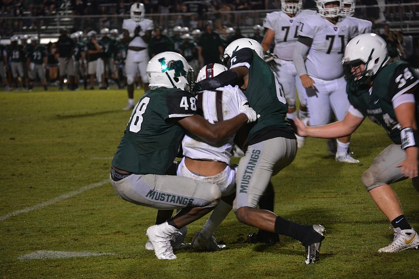 Lakewood Ranch defenders Jerome Minton and Blauvelt Georges make a sandwich out of Braden River wide receiver Craivon Koonce.