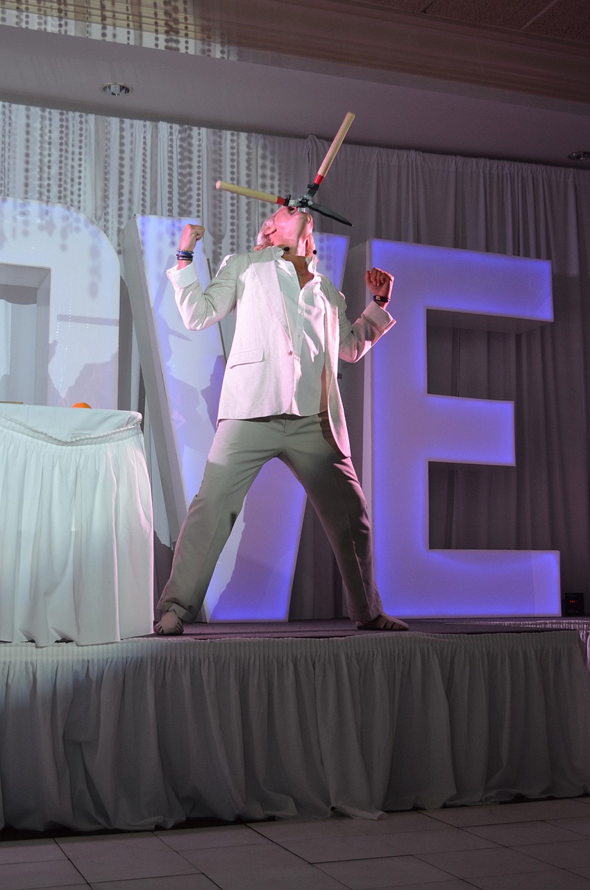 A sword swallowing performance gets serious as a hedge shear gets involved.
