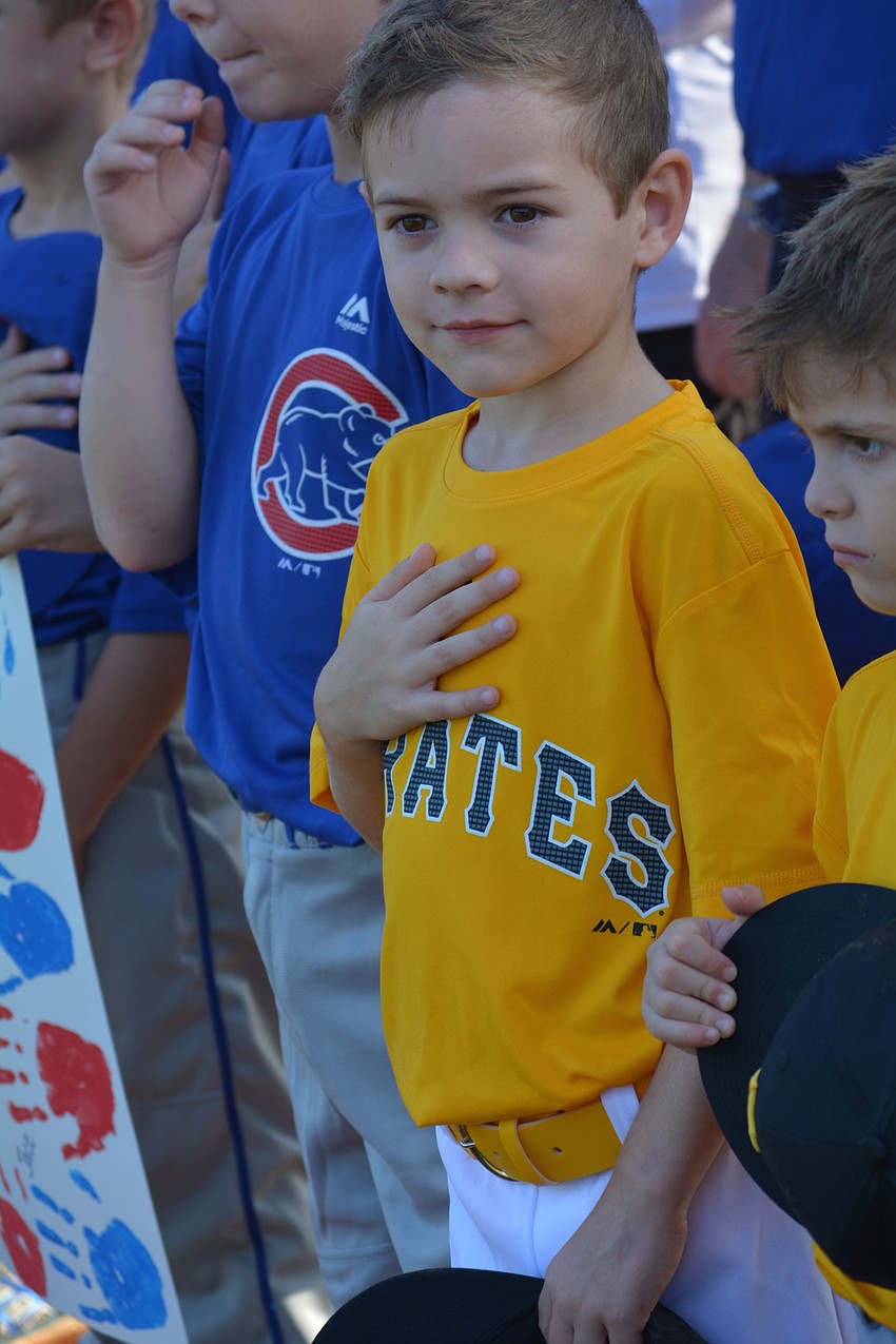 Kaden Pomeroy, 4, stands for the national anthem.