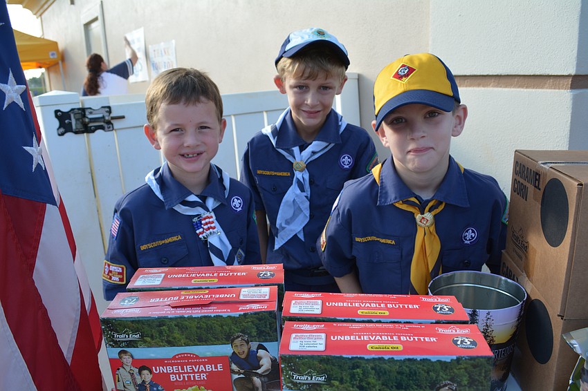 Boy Scout Cub Pack 41 members Blair Chadwick, Lukas Drao and Dylan Rawley sell popcorn.