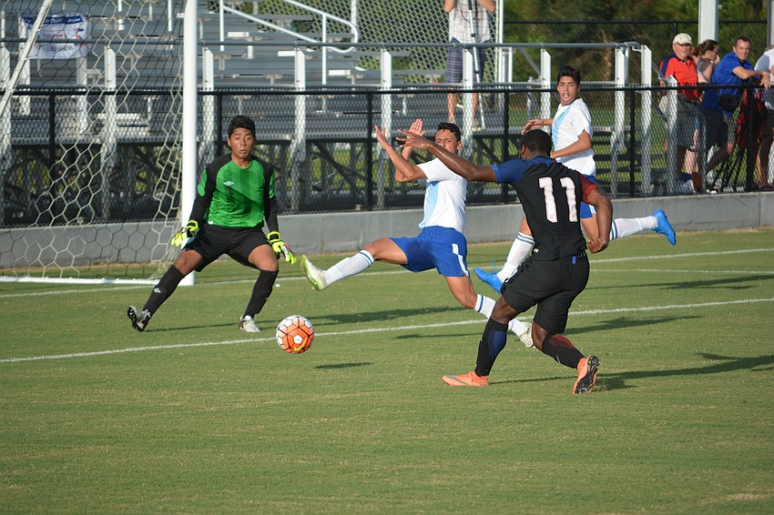 Zyen Jones has a goal despite the efforts of the Guatemala defense.