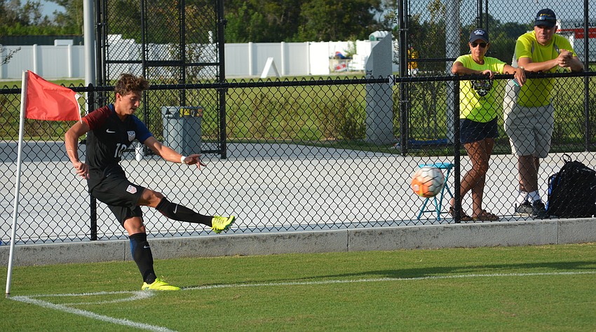 A pair of fans check out George Acosta's corner kick form.