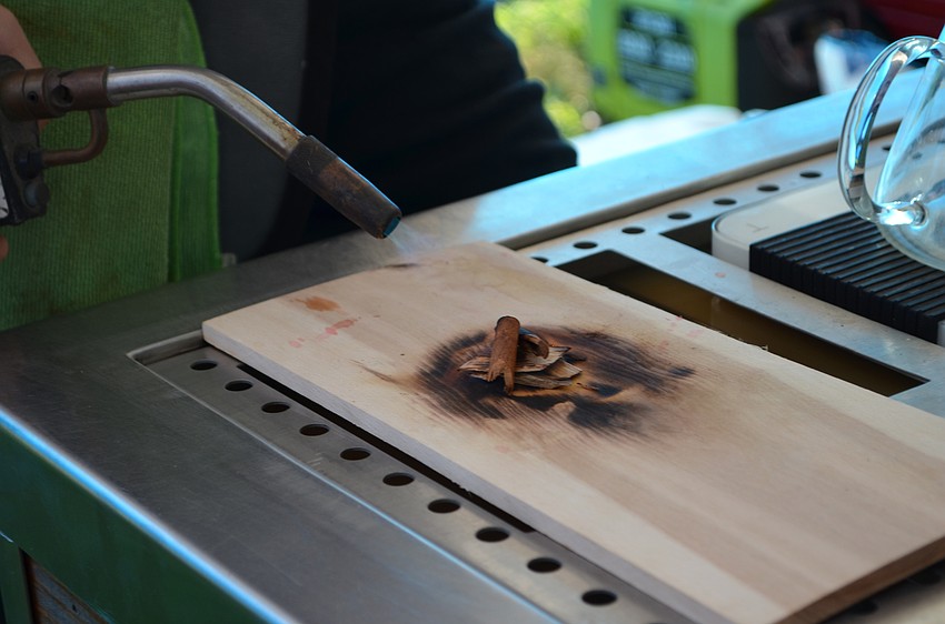 Out and About Coffee crafted a barbecue inspired cocktail coffee by burning cherry wood chips on a hickory plant with a stick of cinnamon.