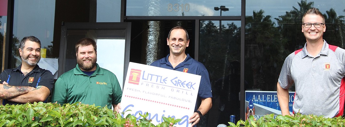The Little Greek crew â€” Joe Marquez, regional manager, Michael Tudor, Tampa manager, Percy Rosemurgy, co-owner, and Ben Hedgecock, LWR general manager â€” stand in front of the soon-to-be Little Greek.