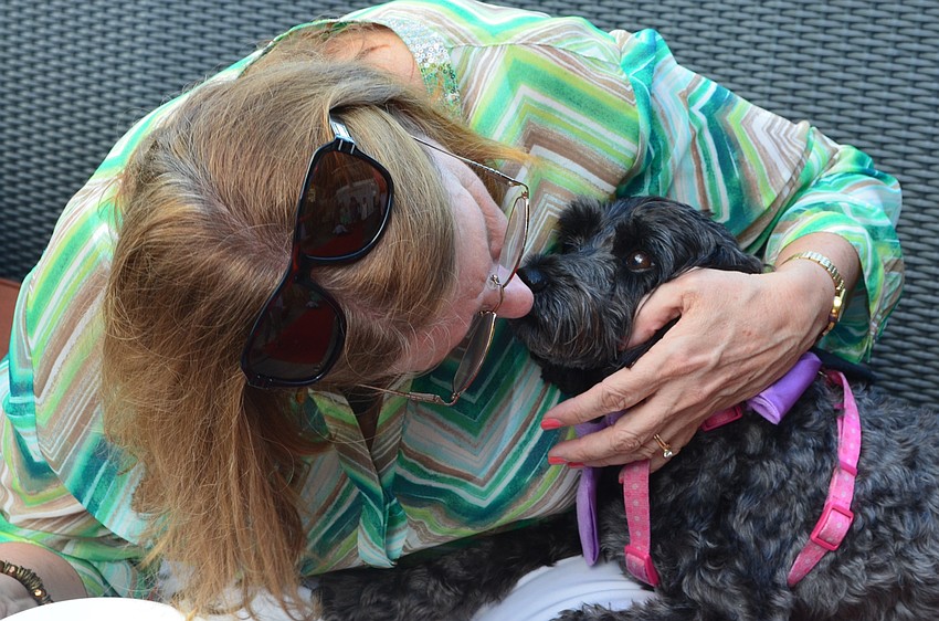 Cindy Jackson from River Club gives her dog Sophie a kiss at the Giving Challenge.