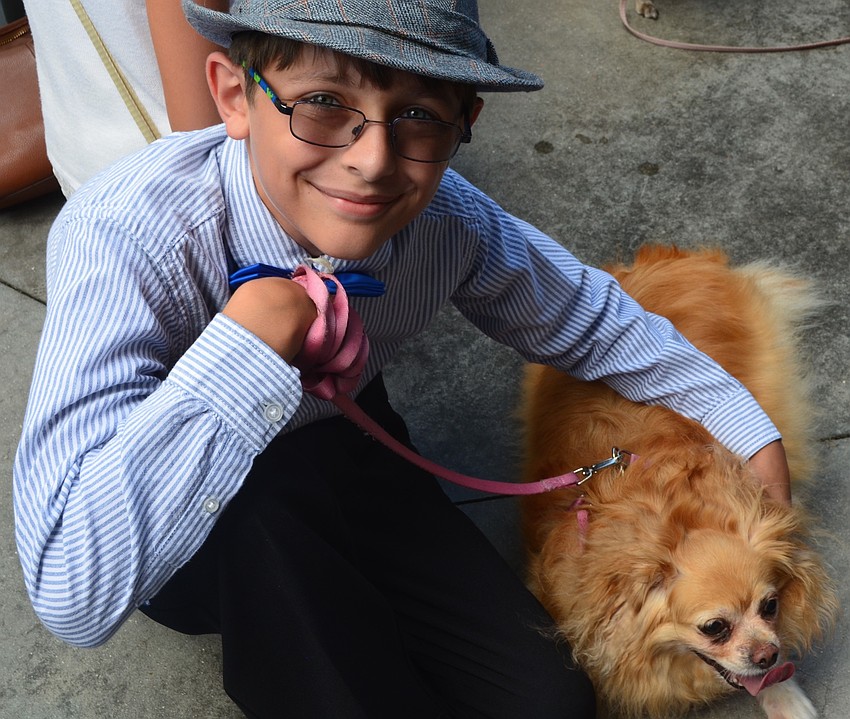 Lakewood Ranch's David Lodwick, 12, sits with his pup Rosie outside at Kona Grill.