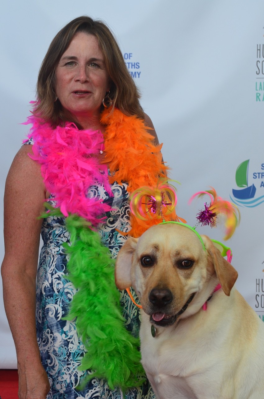 Karen Nicholson, Lakewood Ranch, poses on the red carpet with her dog Nick.