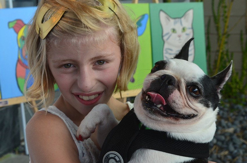 Nicole Gingrich, 11, from Perrish, holds her dog Boo on the red carpet.