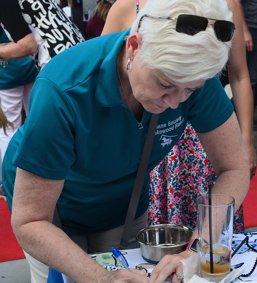 Deanna Murchie, Lakewood Ranch, signs people in at the Giving Challenge.