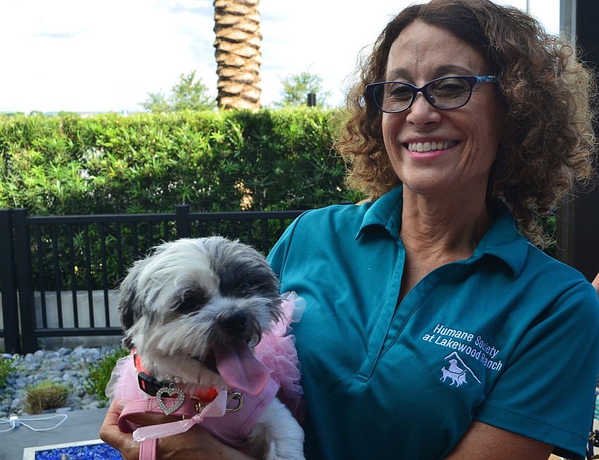 Lakewood Ranch's Virginia Craig, also a volunteer at the Humane Society, holds her dog Lilly at the Giving Challenge.