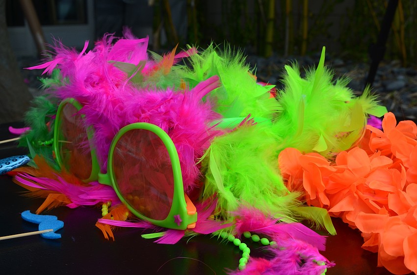 Dress up attire, for the dogs and their owners, lays on a table by the red carpet.