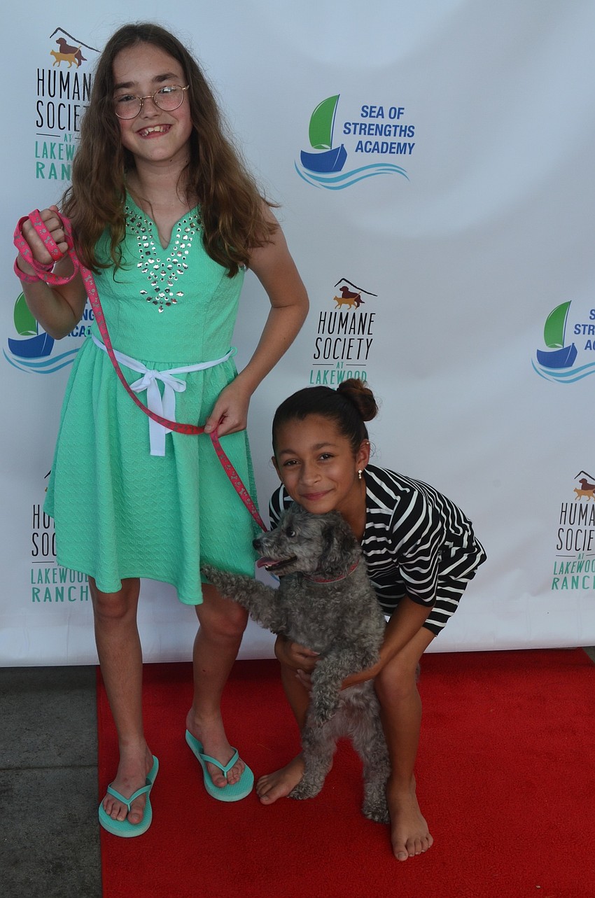 Lilly Riggs, 11, and Gianna Goodwin, 10, both came from Perrish to attend the Giving Challenge. Goodwin stands with her dog Rosie.