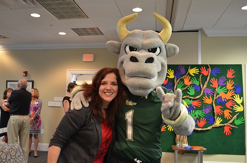 All Faiths Food Bank director of creative services Laura Coyle with the University of South Florida mascot Rocky