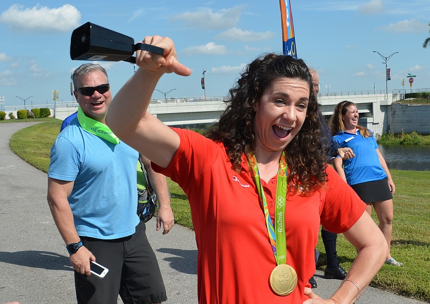Olympic rowing gold medalist Amanda Polk, who performed in Rio with the winning United States women's eight team, signals the countdown to the World Championships with a cowbell.