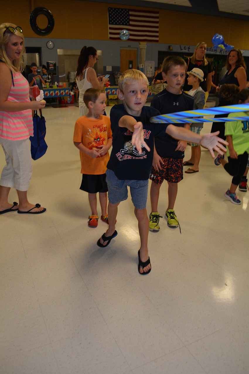 Peyton Deeney, 9, proves to have great aim as he plays a ring toss game and catches the neck of a flamingo.