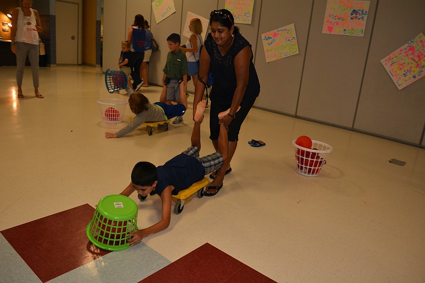 Nadira Rawana-McKelvey pushes around her son, Niall, 9, during a contest of 