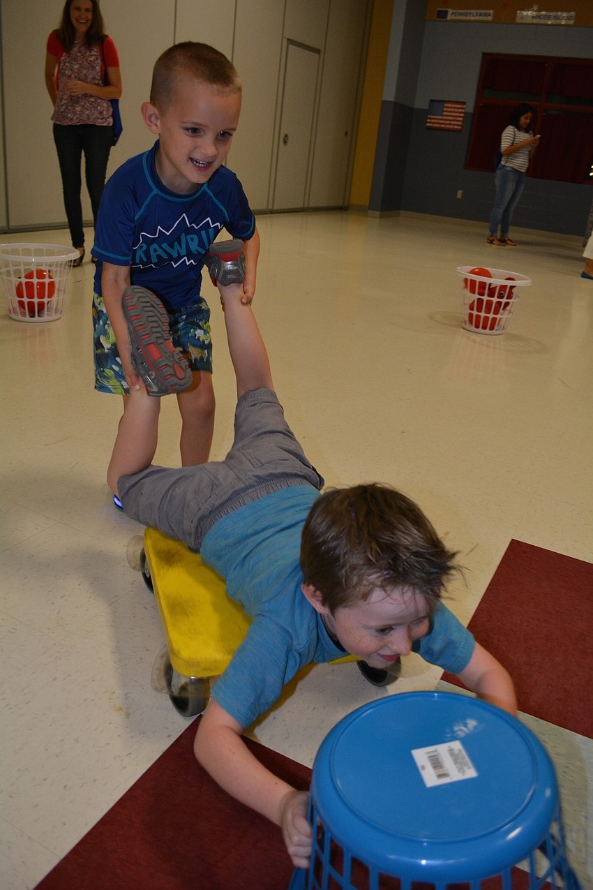 DeagenTerry pushes his classmate Joshua Callaghan in a game of 
