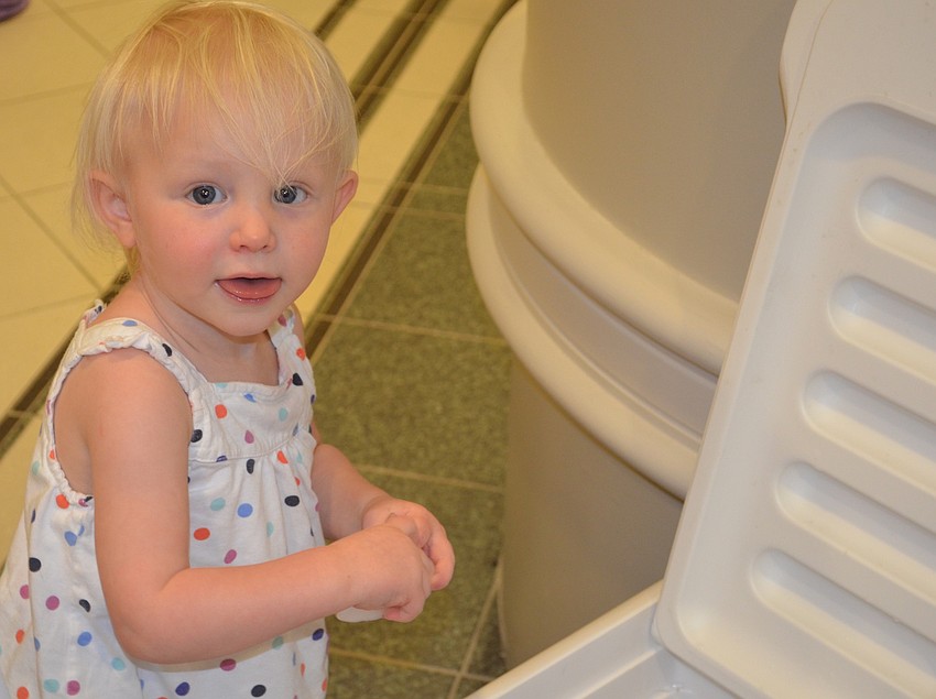 Lakewood Ranch's Paige Porter, 18 months, tries to cool down on a hot day with a few ice cubes.