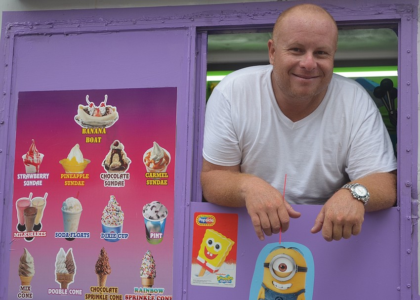 Giovanny Frosty, the owner of Miss Frosty,  waits for customers at the Viva Latino festival.