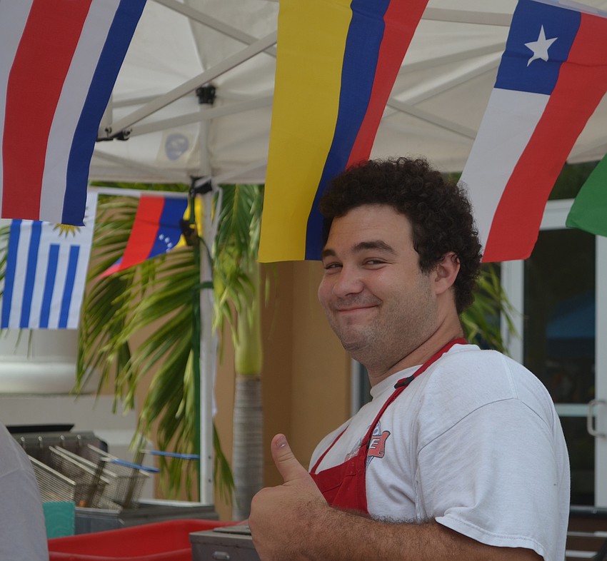 Andrew Hinds, 22, obviously enjoys his work at the Grandma Toni Treats booth.