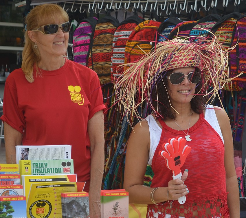 Sarasota's Laura Moonegham and Mariam Ortiz keep busy under the Truly Nolen Pest Control tent.