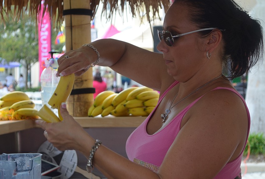 Daniela Steiner, owner of Maui Wowi Hawaiian Smoothies, peels a banana for a drink.