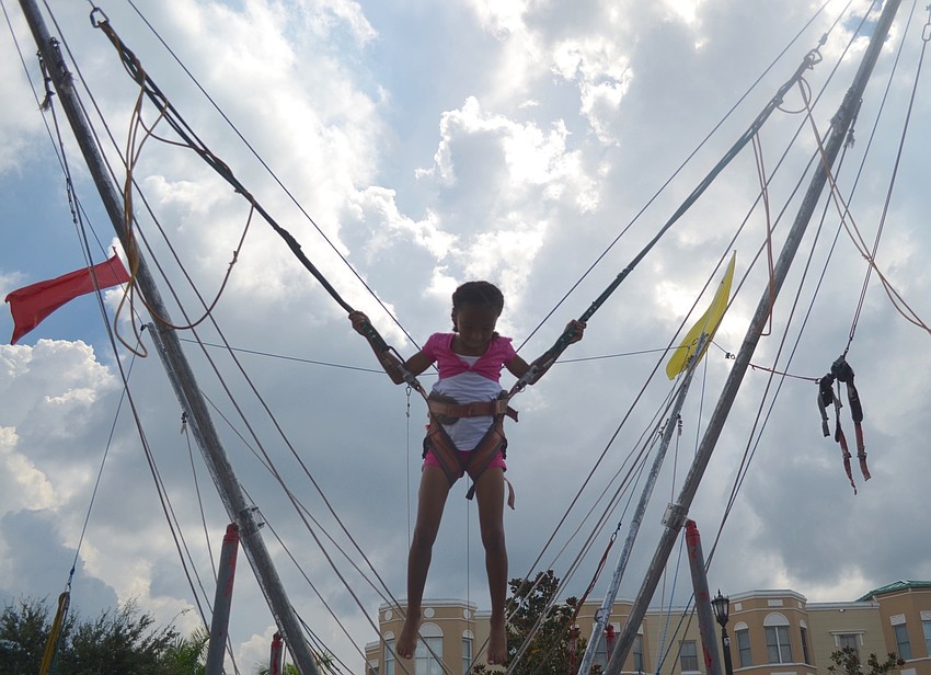 Palmetto's Maya Change, 8, bounces away at the Viva Latino Festival.
