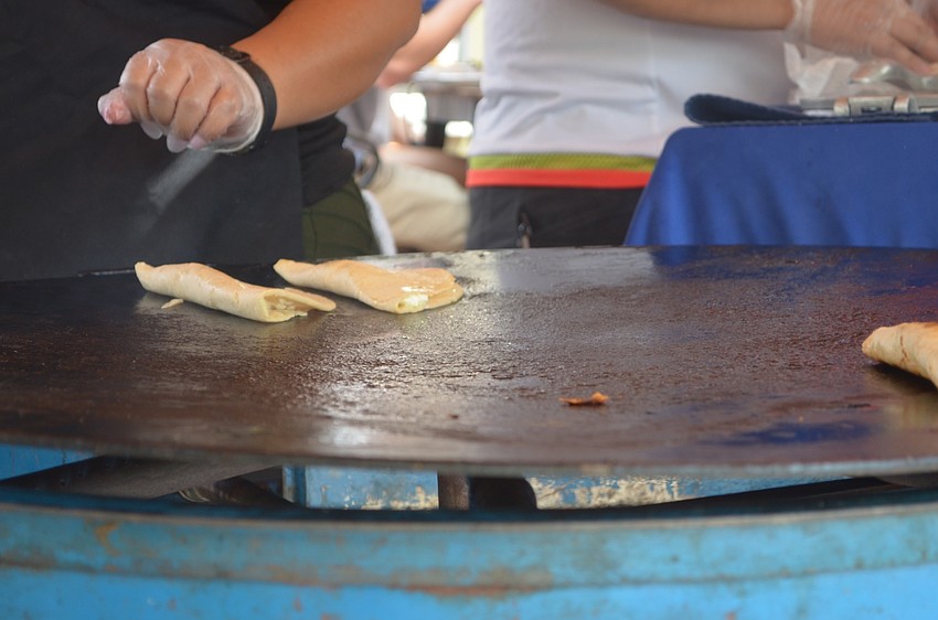 Sarasota's Hortencia Ponce sets a few quesadillas on the grill and waits for them to cook to perfection.