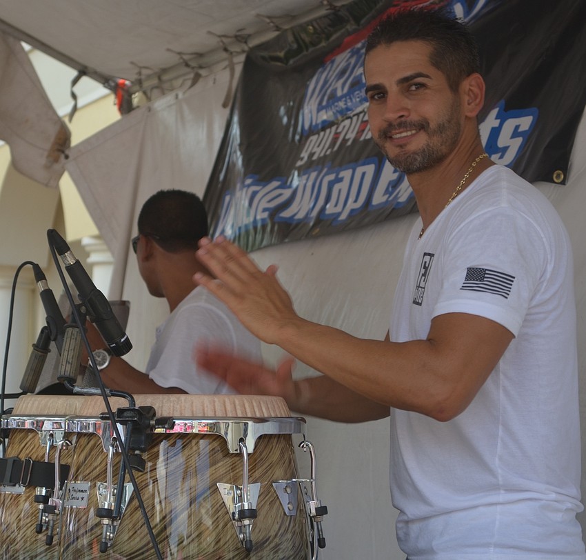 Victor Aular plays the congas as his Sarasota band, FJ One, performs at the Viva Latino Festival.